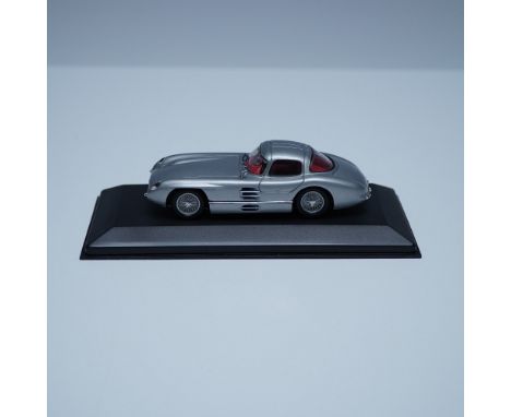A finely detailed Minichamps model of the legendary 1955 Mercedes 300 SLR Coupe, a car renowned for its sleek design and race
