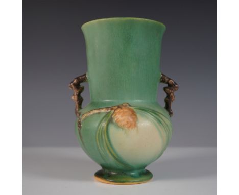 Features the Roseville Pottery vase in the Pinecone pattern,  this classic Art Deco-inspired design features a textured green