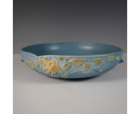 This piece is a classic example of the renowned Roseville Pottery craftsmanship from the mid-20th century. Featuring a raised