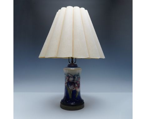 Moorcroft pottery table lamp featuring the Iris pattern, designed by celebrated ceramic artist William Moorcroft. The lamp is