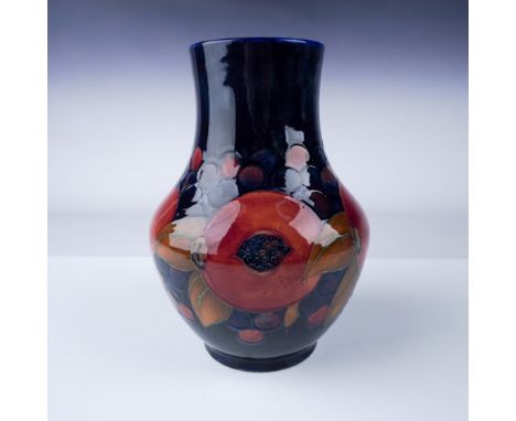 This exquisite vase features a vibrant design of ripe pomegranates and dark berries set against a deep cobalt blue background