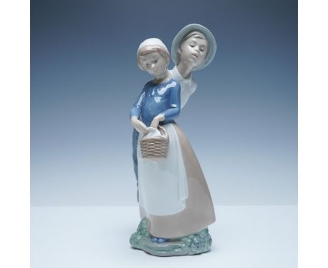 Charming NAO by Lladro porcelain figurine titled Goody Basket. This beautifully sculpted piece captures a tender moment betwe
