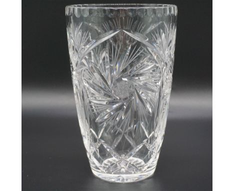 A stunning crystal vase featuring a beautifully intricate cut glass design with starburst motifs. The elegant flared top and 
