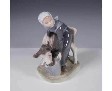 A charming Royal Copenhagen porcelain figurine titled "Girl with Calf," model number 779. This piece depicts a young girl in 