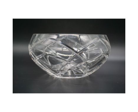 This elegant cut crystal glass bowl features intricate geometric cuts in a starburst pattern, enhancing its reflective qualit