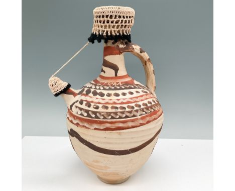 A vintage handcrafted ceramic pitcher signed "Liban," showcasing traditional tribal-style patterns in earthy red and brown to