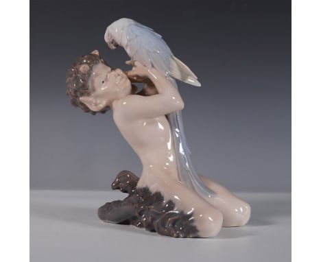 A charming Royal Copenhagen porcelain figurine, model 752, featuring a playful faun kneeling while joyfully holding a parrot.