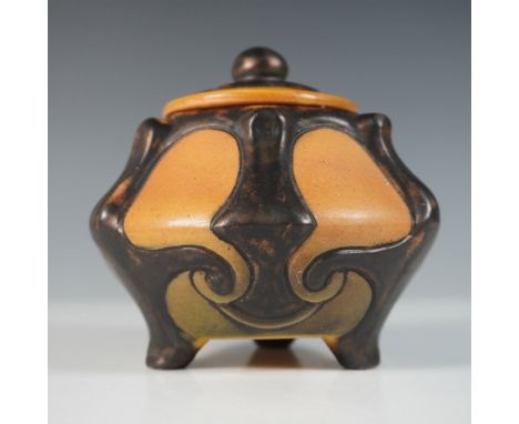 A striking Art Nouveau lidded jar by P. Ipsen Enke, featuring a sculptural form with organic curves and raised relief decorat