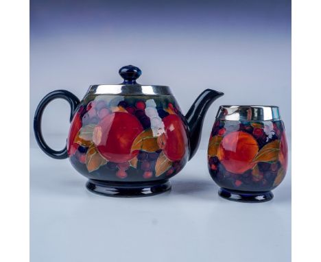 A stunning 2 piece tea service set by Moorcroft, renowned for their hand painted pottery and distinctive Art Nouveau designs.