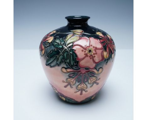 This exquisite Moorcroft pottery vase features the 'Oberon' pattern, a design by renowned artist Rachel Bishop. The vase show