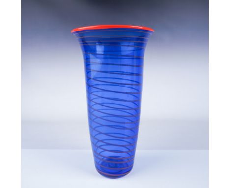 A striking art glass vase featuring a vibrant blue body accented with horizontal orange bands and a bold orange rim. This pie