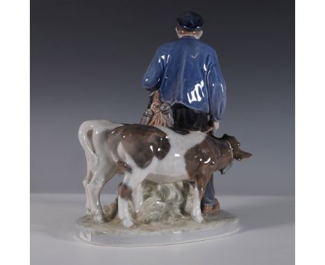 This Royal Copenhagen porcelain figurine, model number 1858, depicts a Danish farmer guiding two young calves. Crafted with r