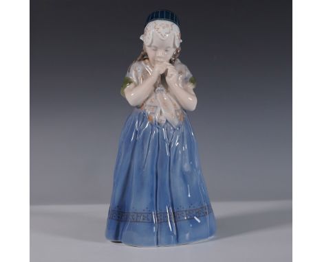 A beautifully crafted Royal Copenhagen porcelain figurine, model 1323, titled Girl from Bornholm. Designed by Lotte Bottger, 