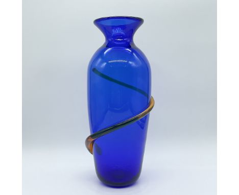 This striking cobalt blue art glass vase by Blenko is a testament to the artistry of American glassmaking. Standing 12 inches
