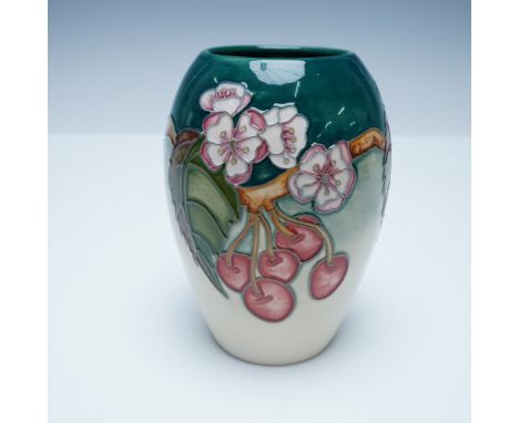 Moorcroft pottery vase featuring a vibrant cherry blossom design. This exquisite hand-decorated piece showcases raised tube-l