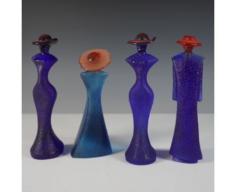 A striking set of four Kosta Boda art glass figurines designed by Kjell Engman. These elegant, elongated figures feature vibr