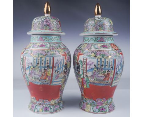 A beautiful pair of Chinese hand painted covered vases, each crafted in a classic plum shape. These exquisite vases feature i
