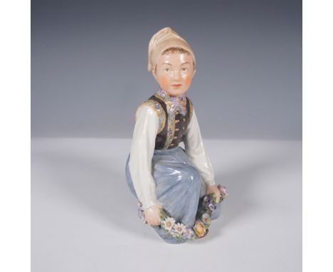 A finely crafted Royal Copenhagen porcelain figurine, model number 12414, depicting an Amager girl in traditional Danish atti