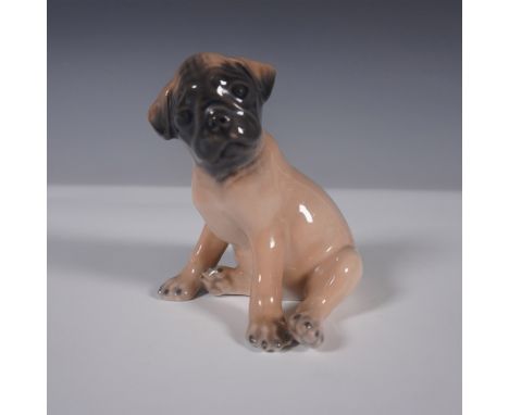 A charming Royal Copenhagen porcelain figurine, model 3169, depicting an adorable seated Pug puppy with an expressive face an