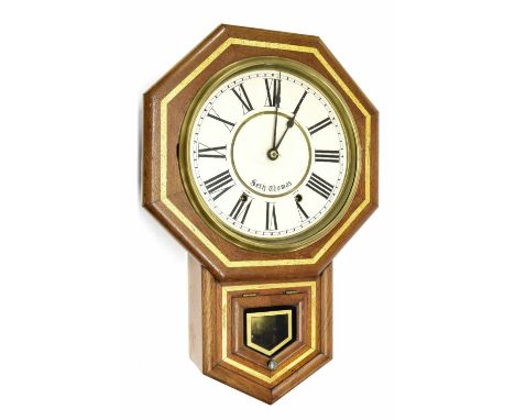 Seth Thomas two train 10" drop dial wall clock, within an octagonal surround over a pendulum window, 22" high (pendulum and k
