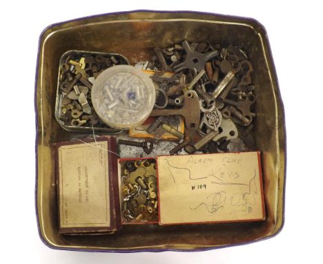Tin containing a quantity of clock winding keys and alarm clock winders