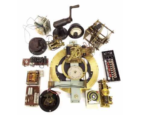 Box of various electrical clock movements, including a Synchronome programmer wheel