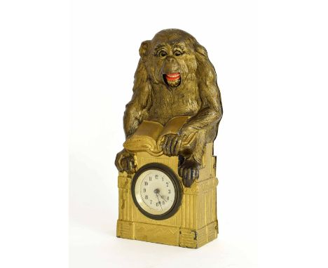 Junghans novelty mantel clock timepiece, the 1.75" silvered dial inset into a Classical gilt pillar and surmounted by a monke