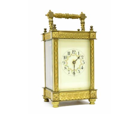 French carriage clock striking on a gong, within an ornate cast case, 8" high