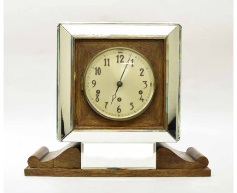 Unusual oak and mirrored three train mantel clock striking on eight rods, the 7" silvered dial within a square canted casing 