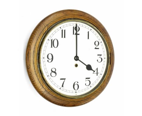 Oak single train 12" wall dial clock, within a turned surround (pendulum and key)