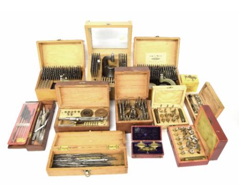 Four good various cased staking sets; also a quantity of other small cased clock and watch tools