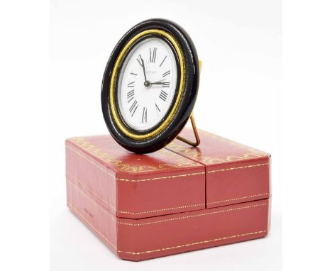 Cartier oval easel travelling clock timepiece, within a folding red and gilded case, 5" high overall