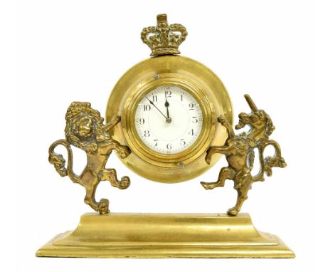 Brass bulkhead style mantel clock timepiece, the 3.5" white dial within a flaring brass surround supported by a lion and unic