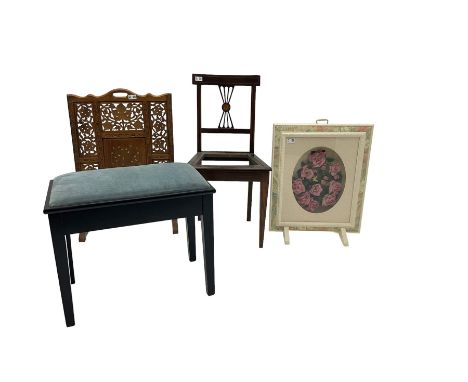 Ebonised piano stool with hinged seat; Hardwood fire screen, pierced and carved with foliate decoration and another screen; E