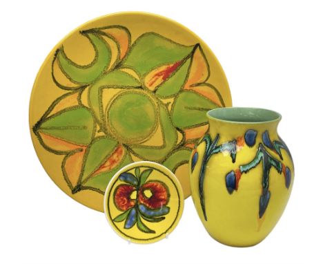 Poole Pottery charger, with a stylised floral pattern on a yellow ground, together with a Poole pin dish and vase of a simila