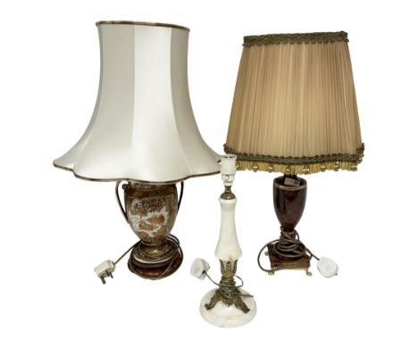 Three table lamps to include oriental style ceramic example, pink marble lamp of urn form and gilt metal mounted lamp, two wi