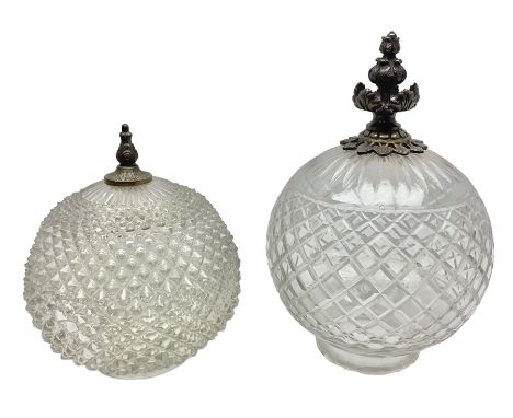 Two clear glass light shades of globular form with foliate metal mounts, tallest H29cm