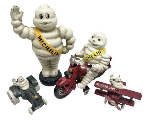Collection of cast metal Michelin men, to include, one on a motor bike, come in a plane, one on a tractor and a large money b