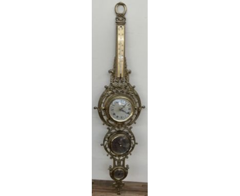 A modern brass barometer with a thermometer 