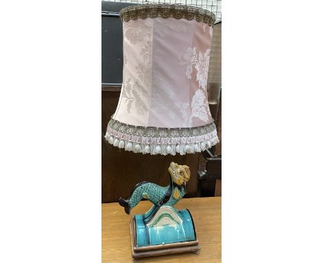 A Chinese pottery fish riding on the crest of a wave mounted in a table lamp