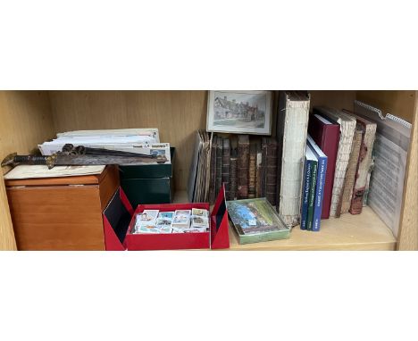 A collection of first day covers, postcards, leather bound books, dagger etc