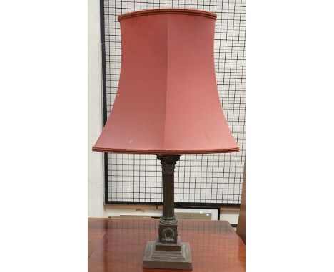 A brass table lamp with a corinthian column on a square base 