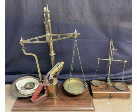 A brass table top scales with brass pans, together with a smaller example and a brass blow torch