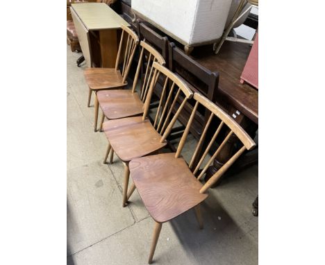  A set of four Ercol stick back dining chairs together with a melamine topped kitchen table  CONDITION REPORT: All in well us