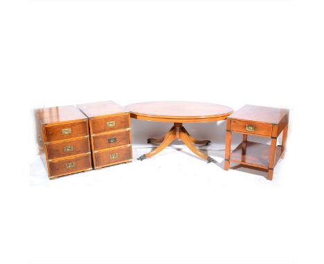 A yew wood effect oval coffee table, splayed legs, 123cm x 71cm; a pair of Campaign style pedestal chests, each with three dr