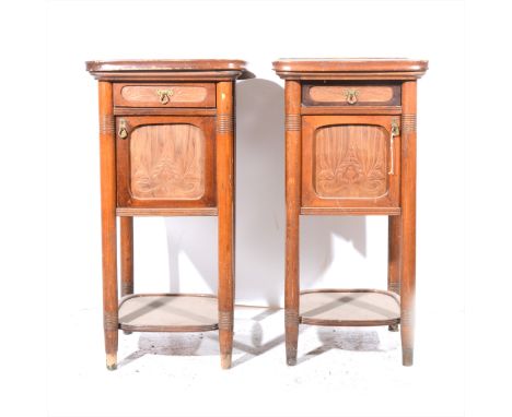 A pair of Austrian beechwood bedside cabinets with marbled tops, by Jacob Josef Kohn, Wien, each fitted with a drawer over an