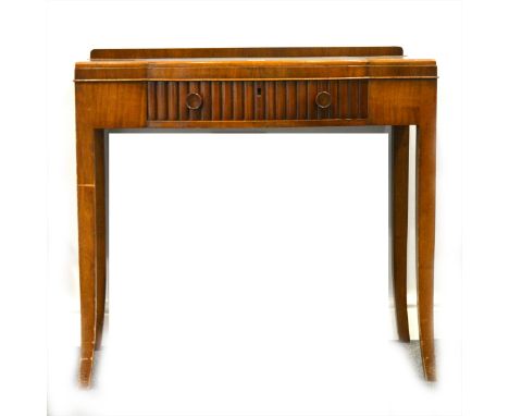 An Art Deco style walnut writing table, inset top, bowfront centre drawer, width 87cm.