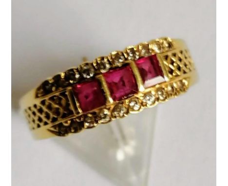 A three-stone ruby and diamond half-hoop eternity ring on a gold setting, each cushion-cut ruby 3mm x 2mm, size Q, stamped 75