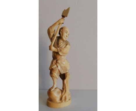 A Meiji period carved okimono of a woodsman with axe, signed to base, 21 cm H 