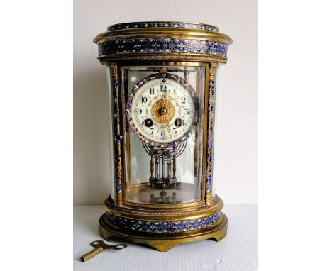 A late 19th century oval French gilt champleve mantel clock with four bevelled panels, Arabic numerals, painted dial, twin ja